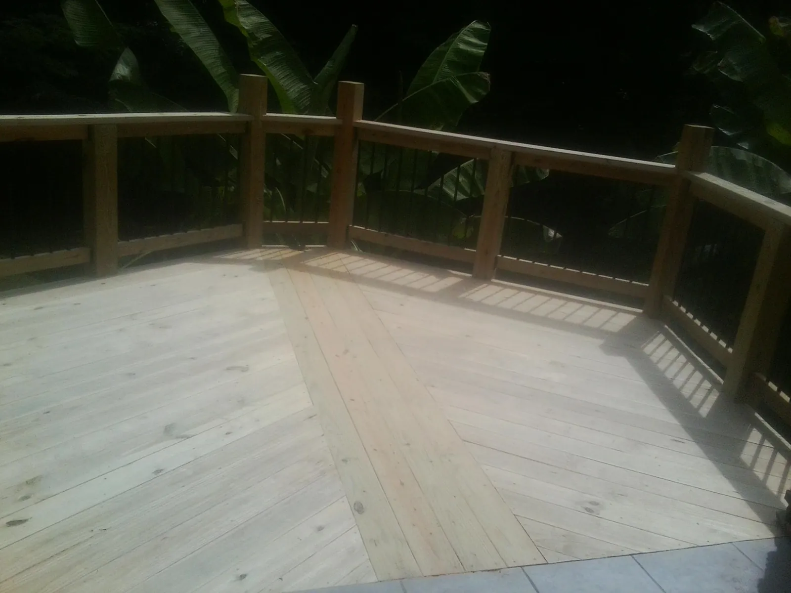 New wood deck and railing built off the back of a home in Bridgeport